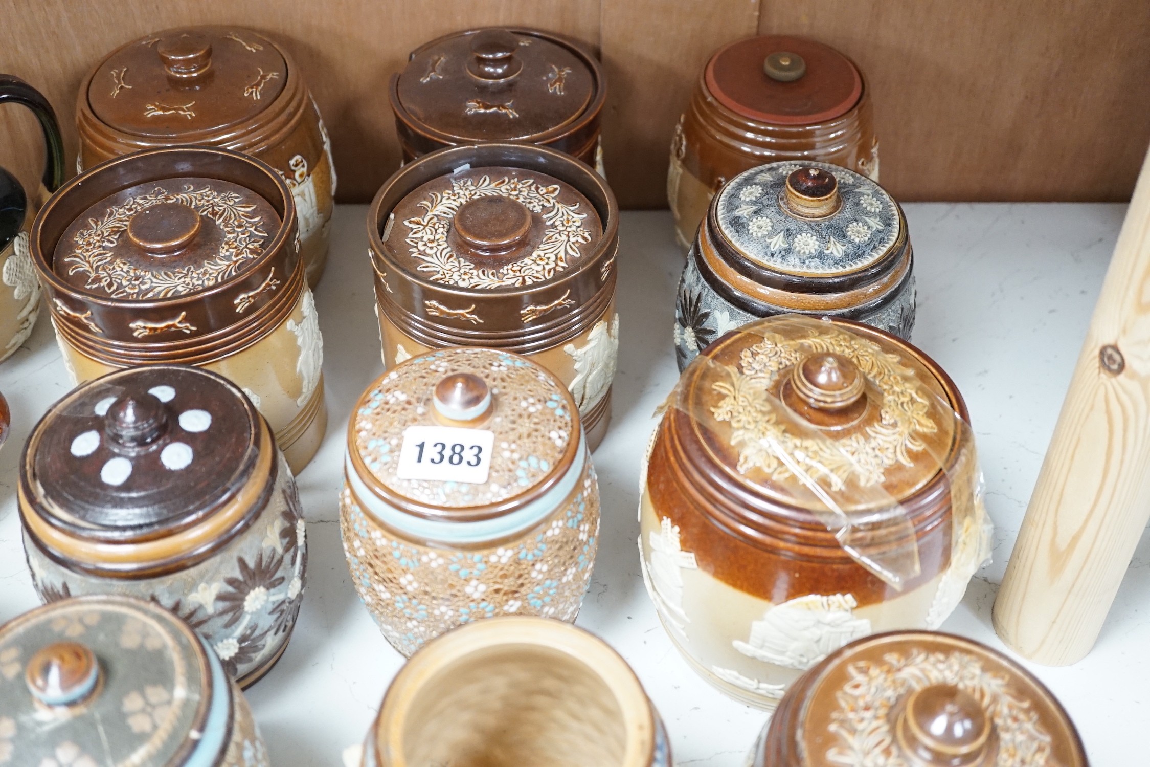 A quantity of Doulton stoneware tobacco jars and jugs